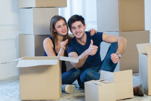 Movers carrying boxes down stairs during a flat removal